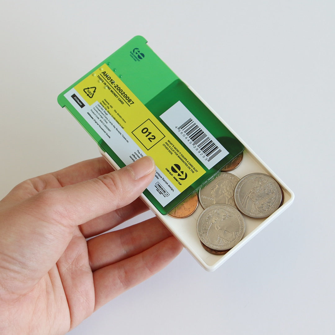 Hand holding an open white card and coin case, showing coins inside and a Green card slid on top.