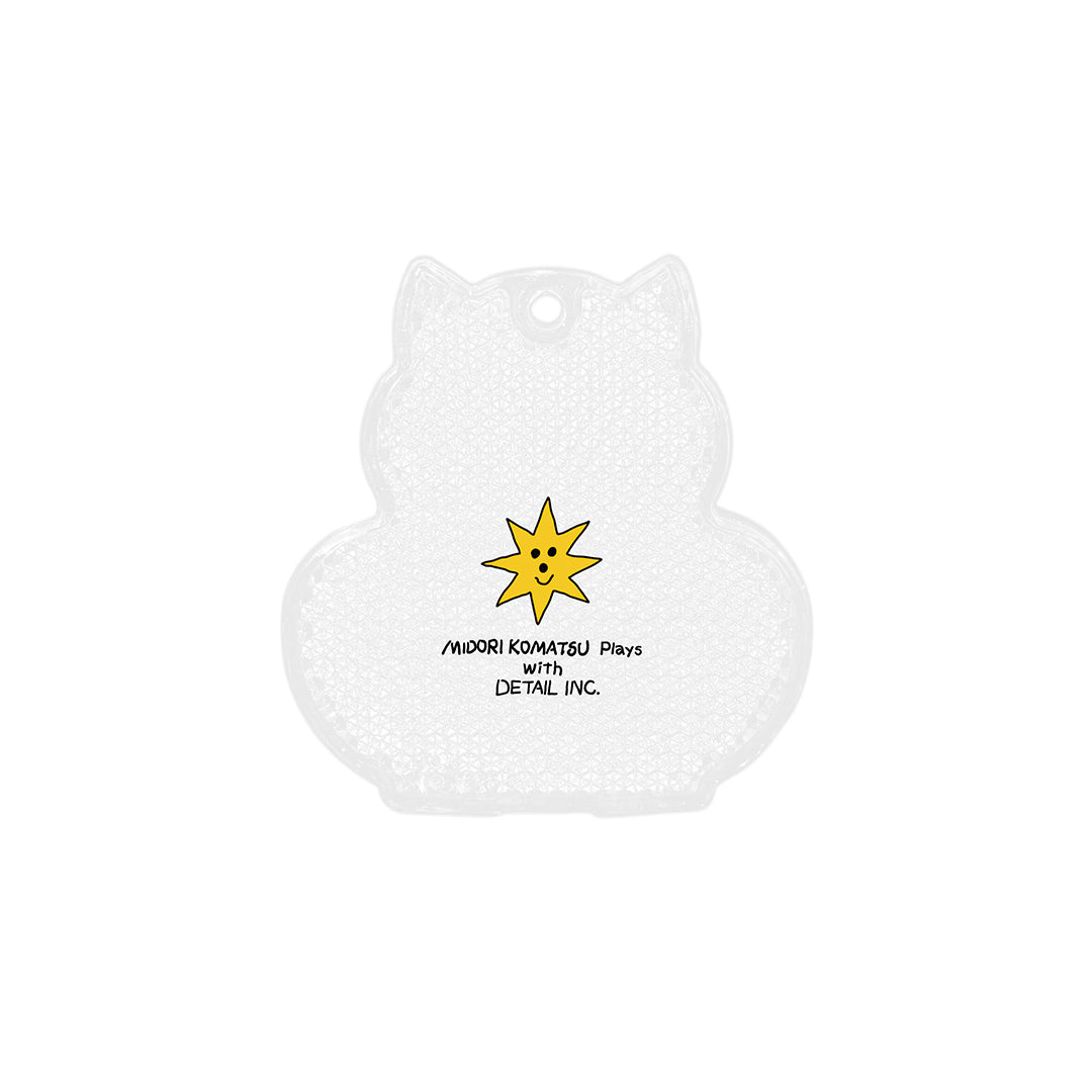 Back of cat-shaped reflector keychain, white textured surface with yellow smiling star and printed text