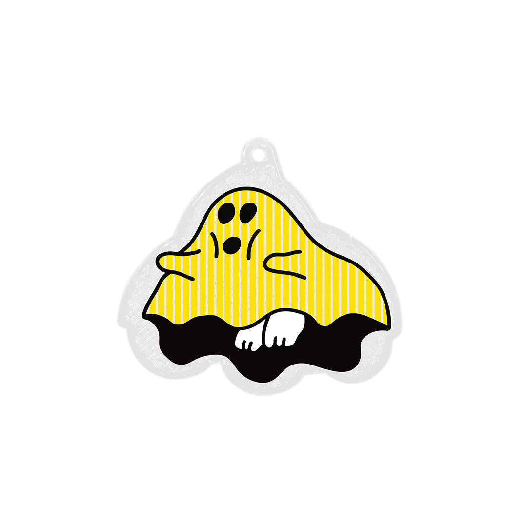 Ghost-shaped reflector keychain with a yellow striped sheet, black base and small hanging hole at the top.