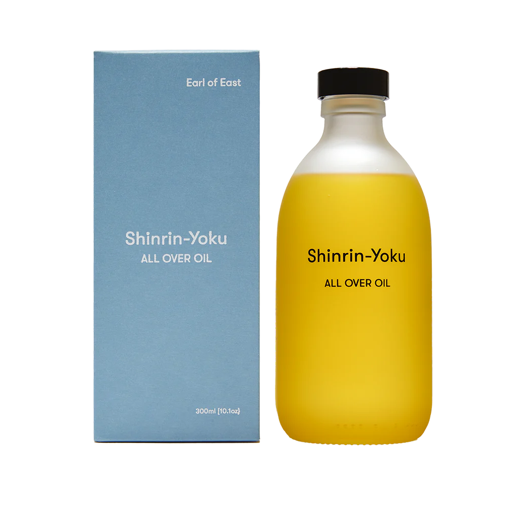 Earl of East Shinrin-Yoku All Over Oil in a frosted glass bottle with black cap, beside its blue box.