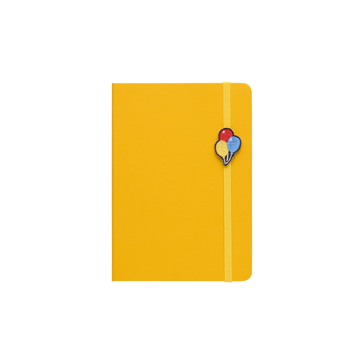 Yellow hardcover A6 planner with elastic band closure and embroidered balloons charm on the front cover.