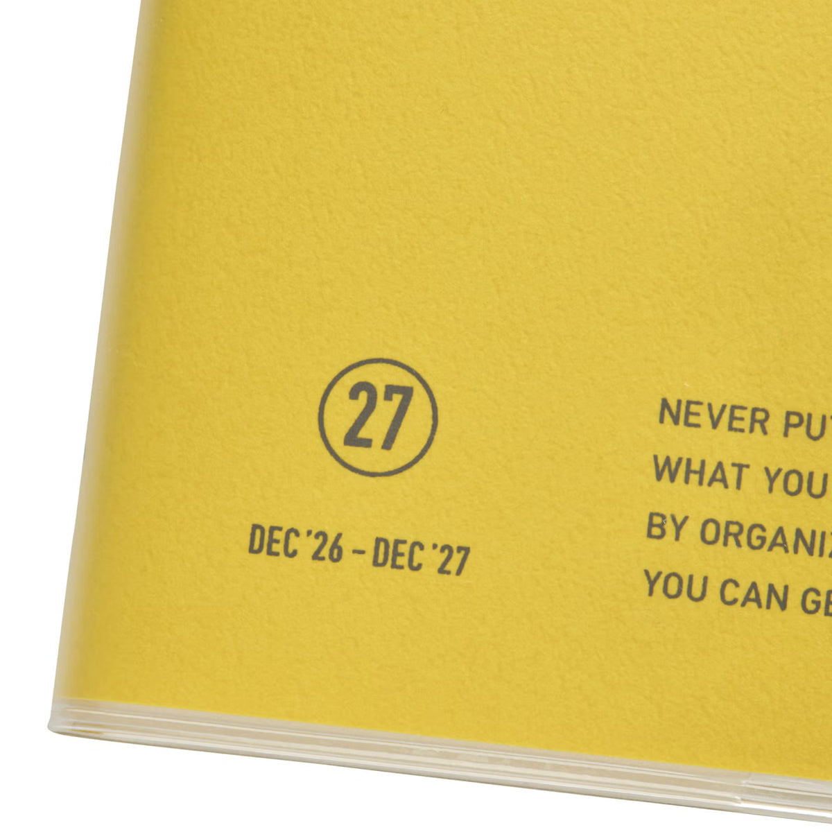 Close-up of the Yellow Nähe planner cover showing the circled 27 and "Dec '26 – Dec '27" printed text.