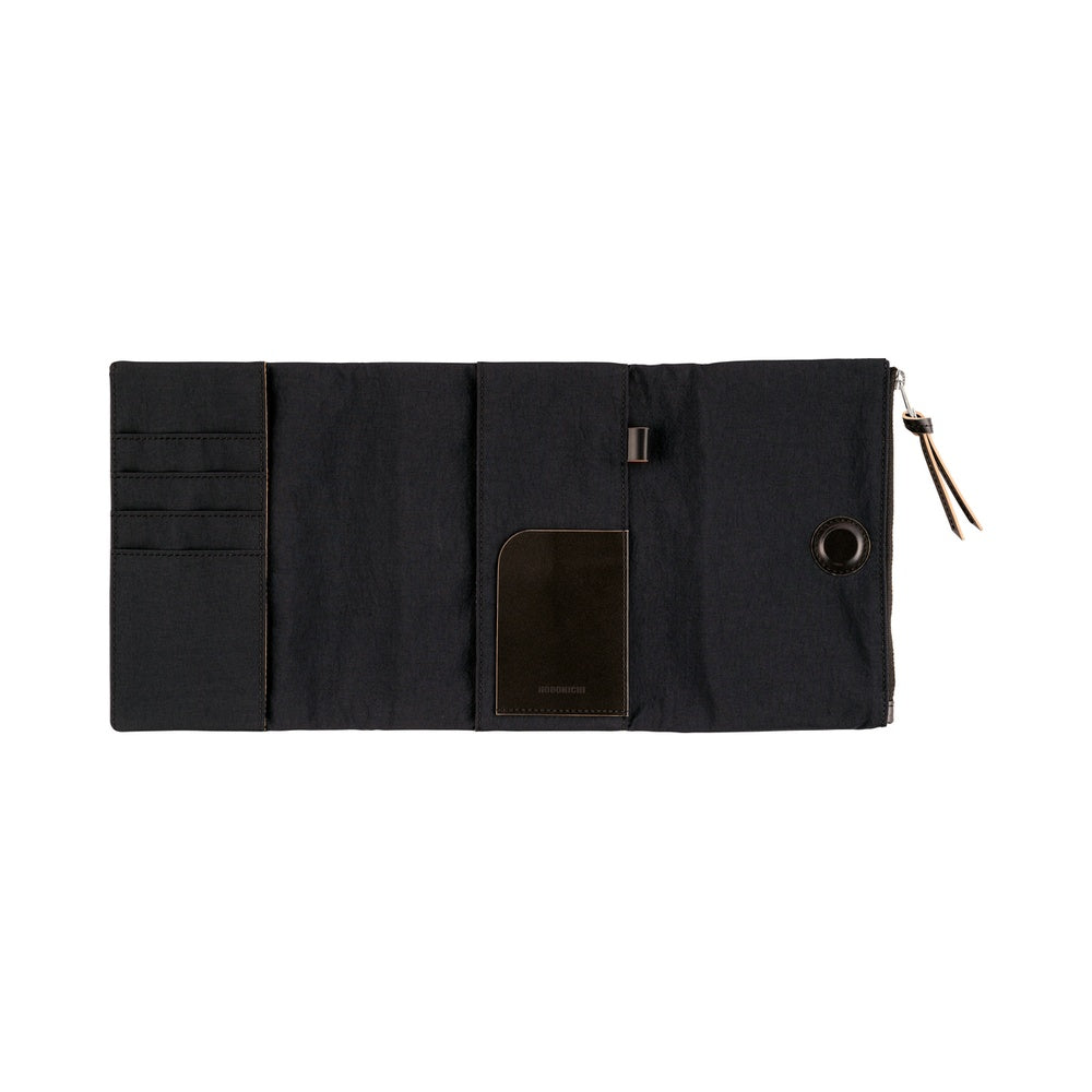 Hobonichi A6 Tragen book cover in Black, unfolded flat to show card slots, pen loop and zip pull.