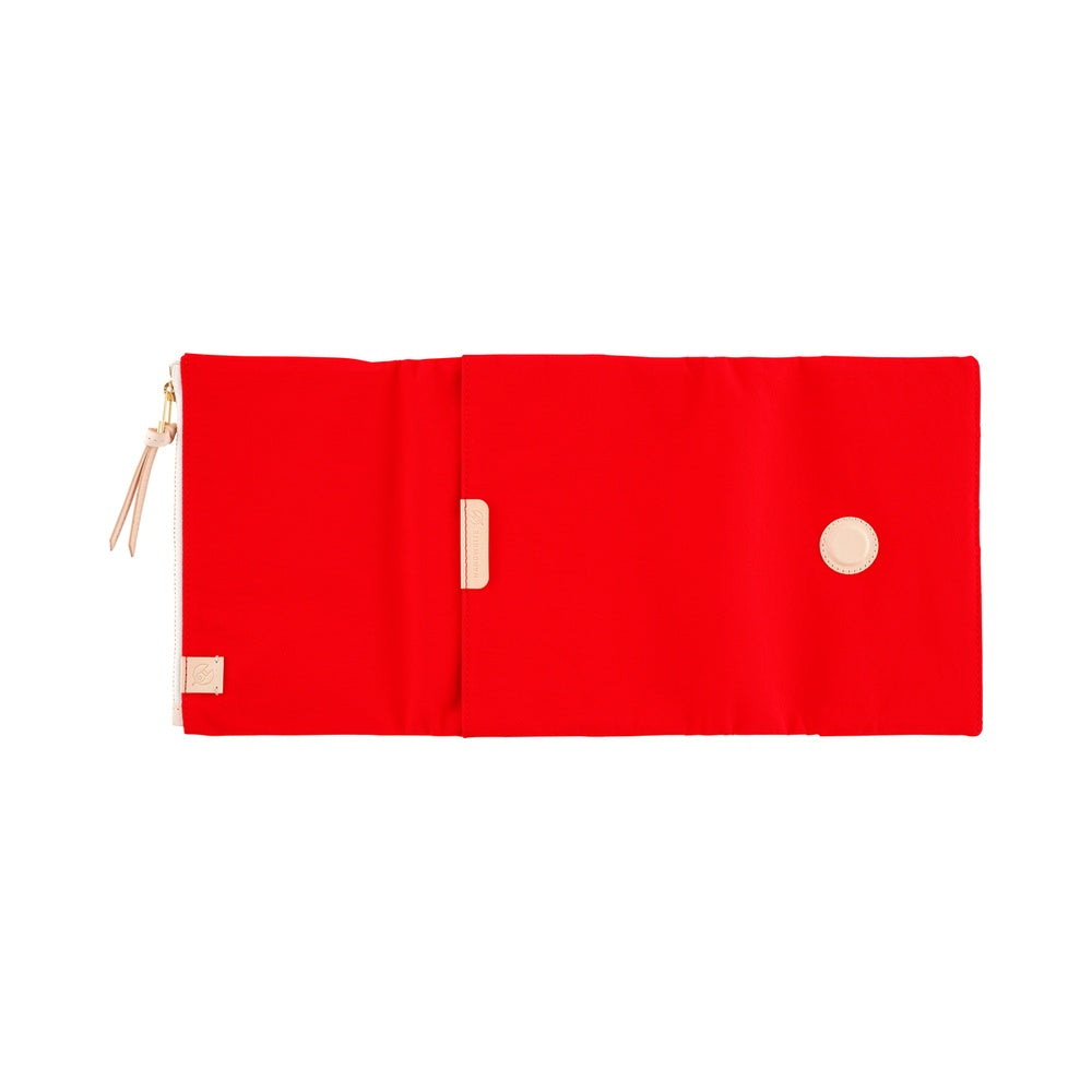 Red A6 Hobonichi book cover laid flat open, with zip pocket, leather pull tab, tab and round stud
