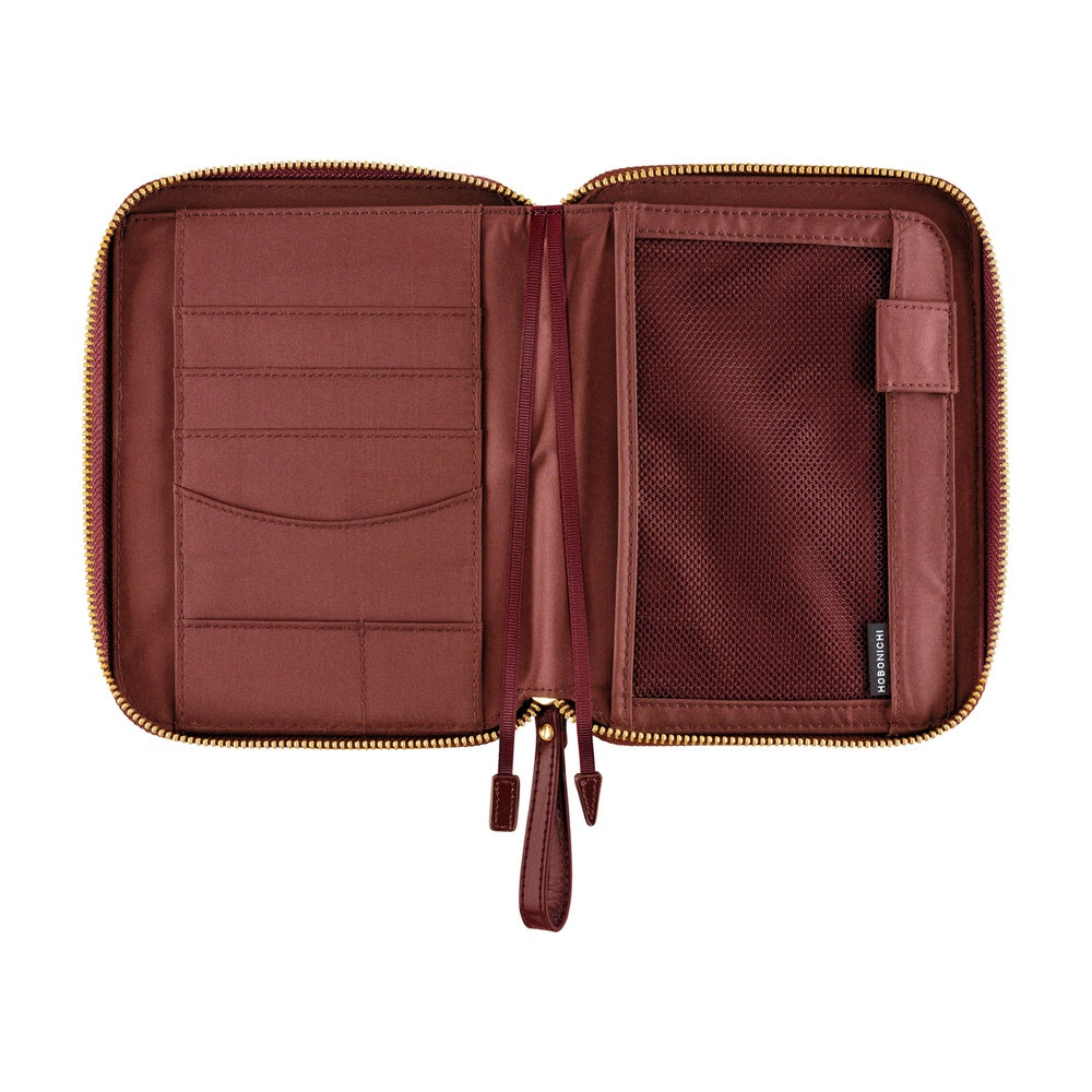 Hobonichi A6 zip cover in Amarone, opened flat to show card slots, mesh pocket, pen loop and zipper pull.