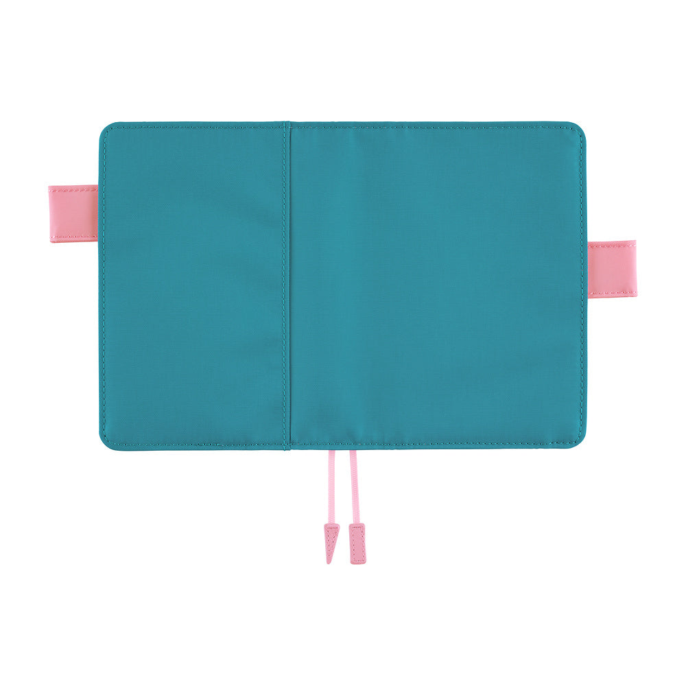 Hobonichi A6 book cover opened flat, teal fabric exterior with pink side flaps and pink bookmark cords