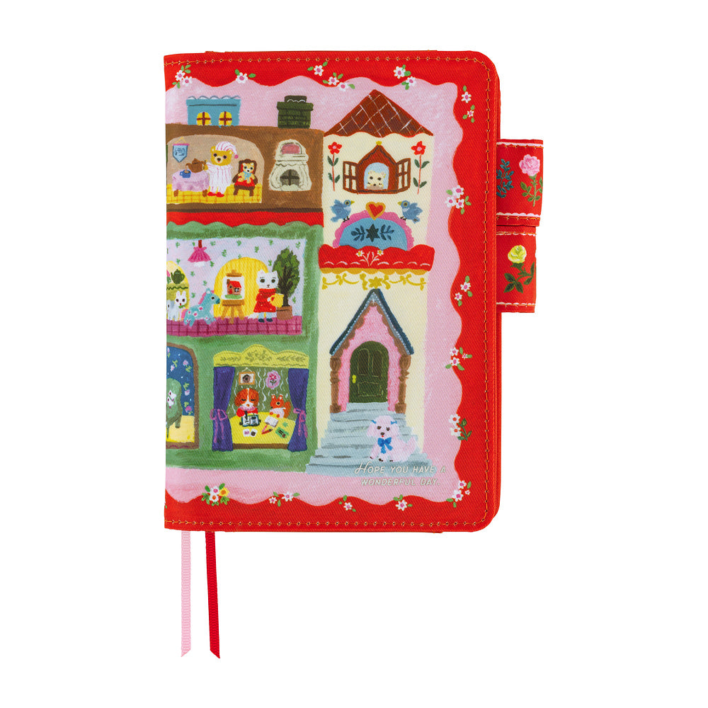 Red A6 book cover with illustrated dollhouse scene of animal characters, floral strap and ribbon bookmarks.