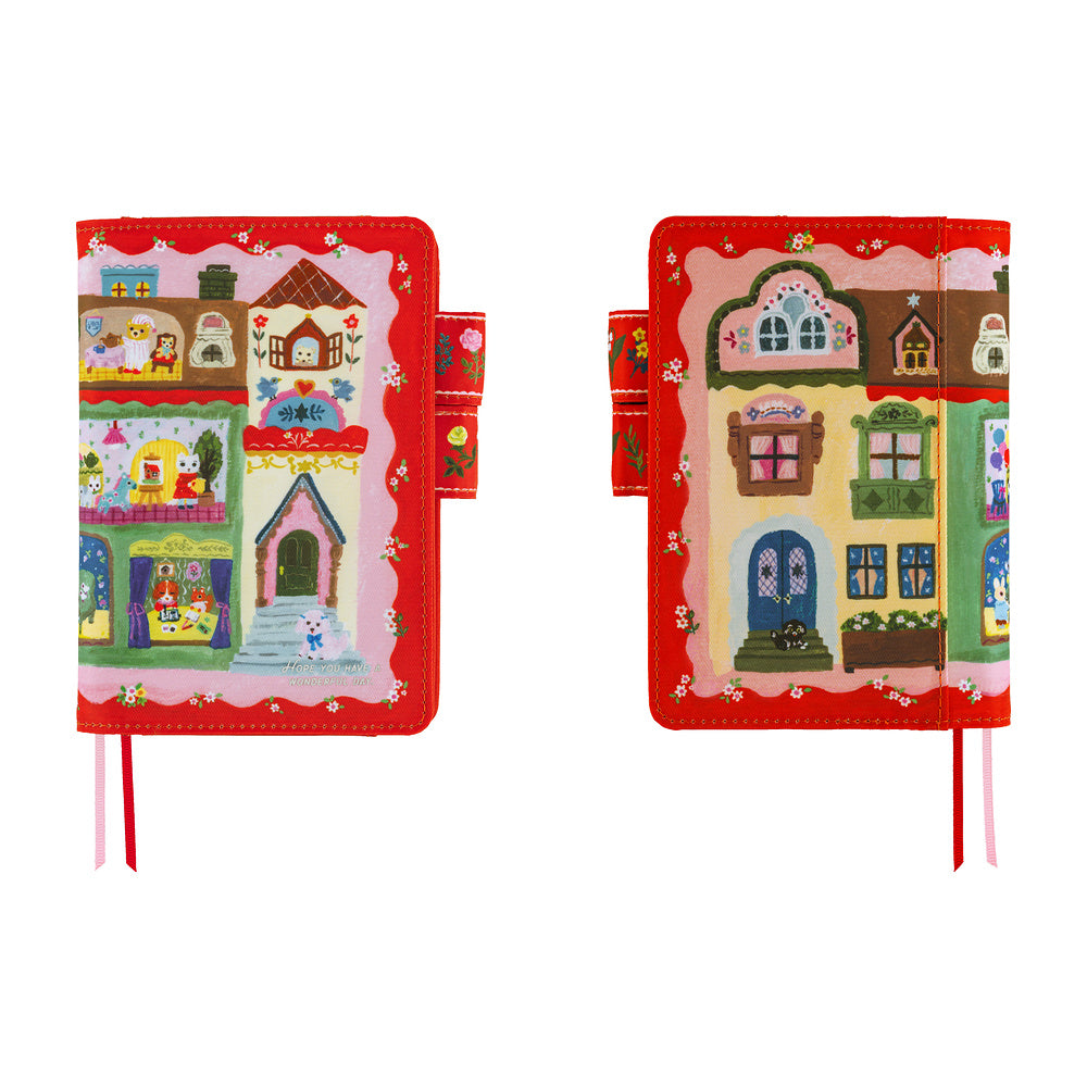 Front and back views of a Red A6 planner cover illustrated with storybook houses, animals and flowers.