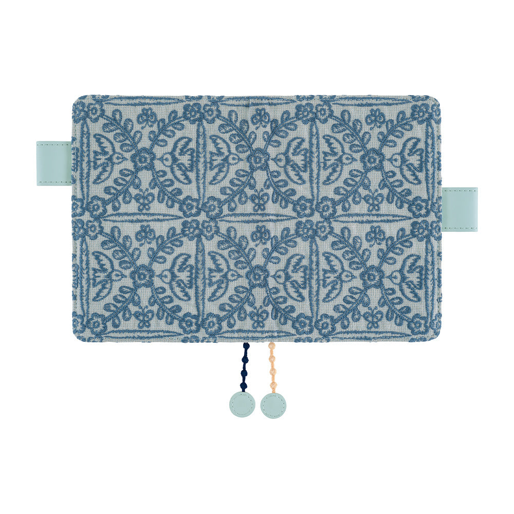 Hobonichi A6 book cover in Blue minä perhonen floral embroidery, with mint side tabs and two round charms.