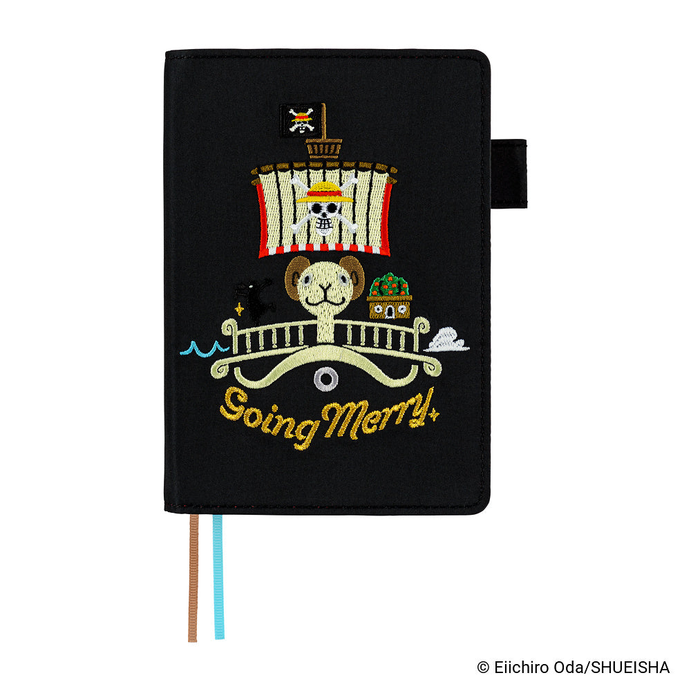 Black A6 book cover embroidered with the Going Merry ship and gold lettering, with two ribbon bookmarks.