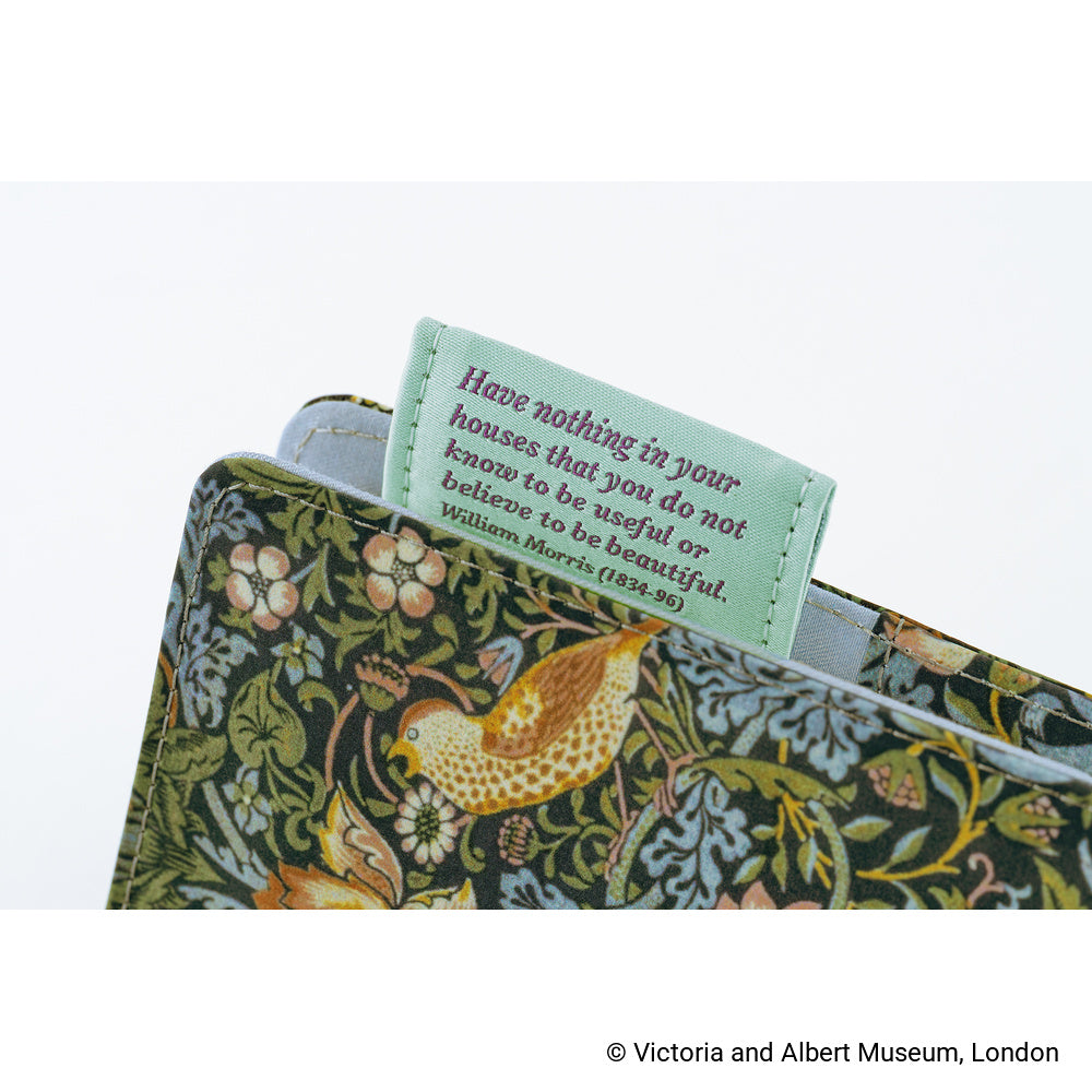 Close-up of Dark Green floral bird-print book cover with a mint bookmark printed with a William Morris quote.