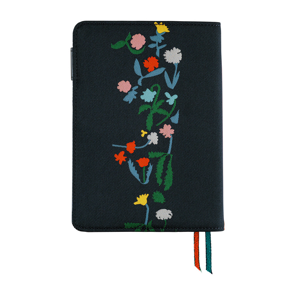 Navy A6 planner cover with a colorful floral vine print, pen loop, and orange and teal ribbon markers.