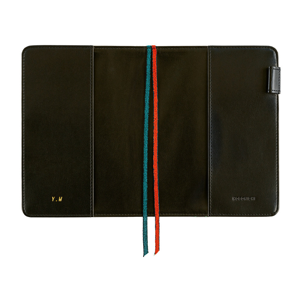 Hobonichi A6 cover opened flat, Navy with gold Y.W initials, teal and red bookmarks, pen loop