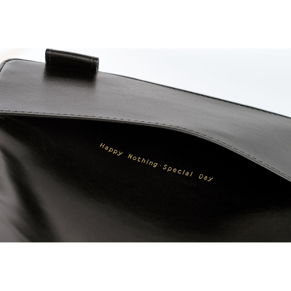 Close-up of dark book cover interior with gold "Happy Nothing-Special Day" lettering and flap