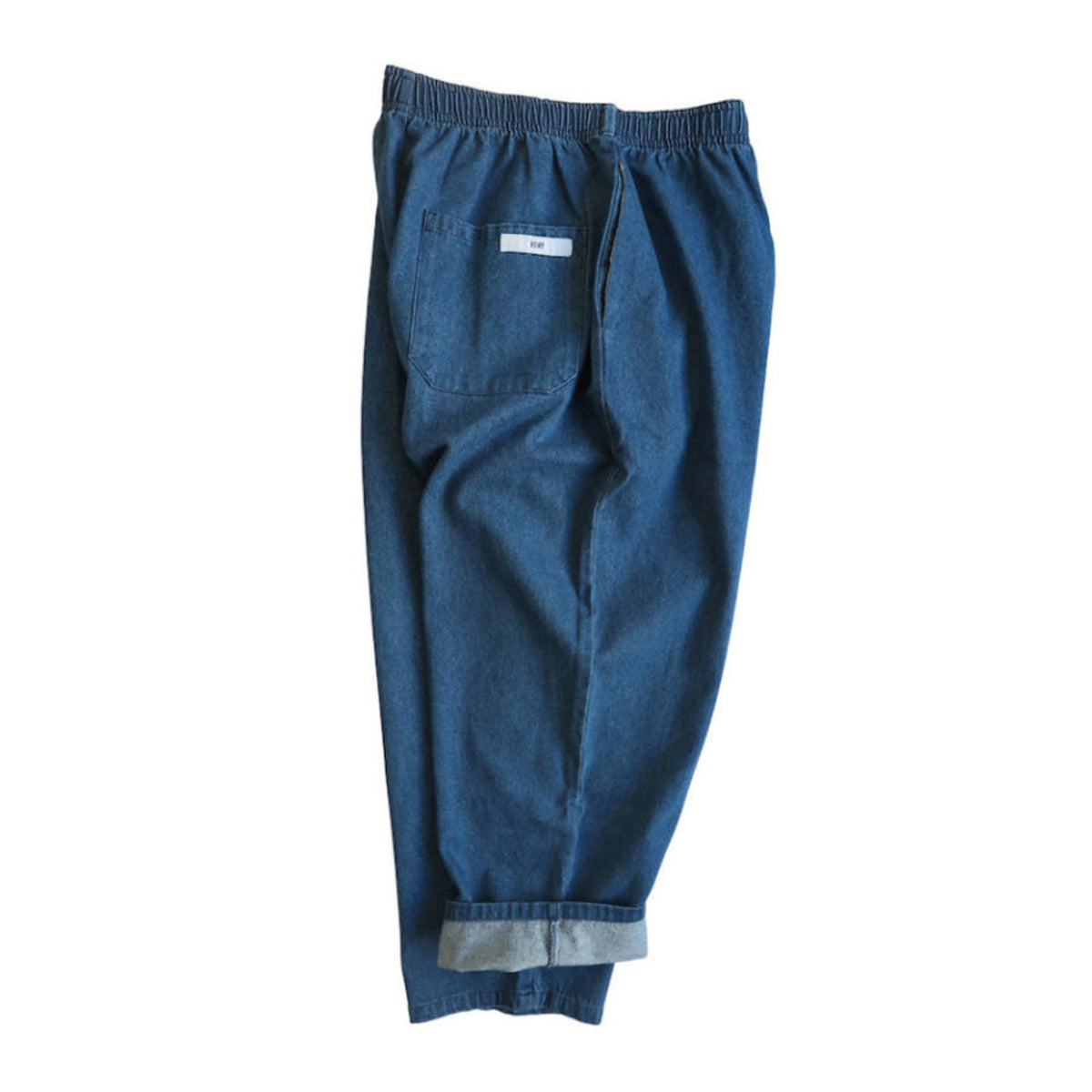 Back view of Voiry Sunday Pants in Mid Blue denim, showing elastic waistband, patch pocket and cuffed hems.