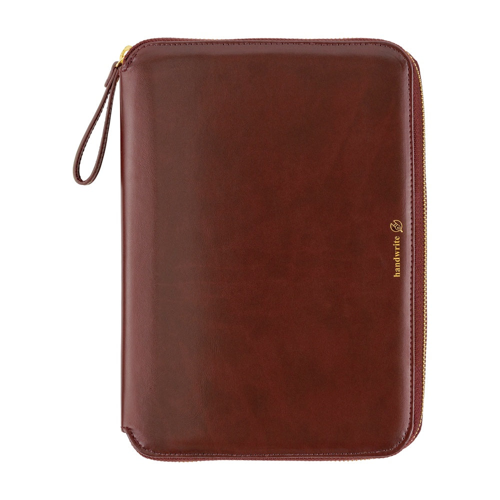 Hobonichi A5 Cousin zip cover in Amarone, closed with gold zipper, wrist strap and gold foil logo