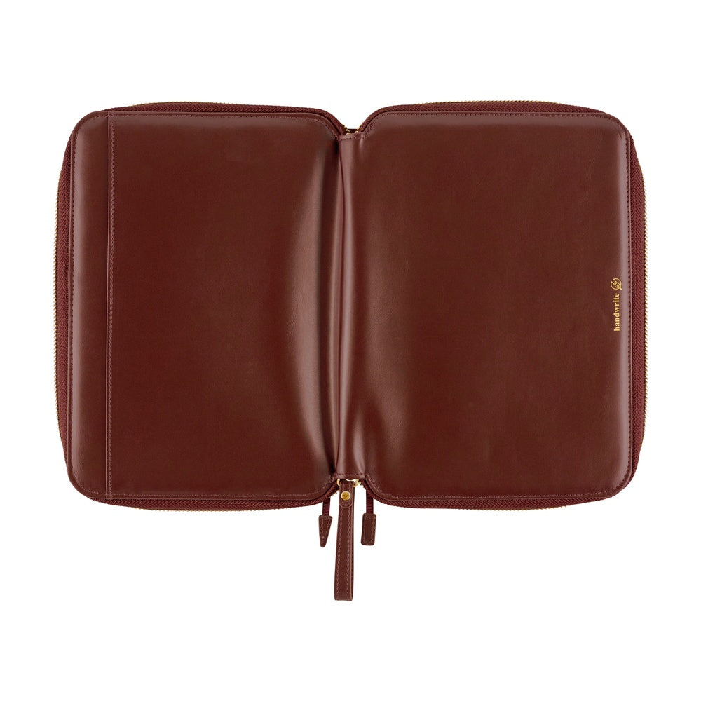 Open interior of an Amarone leather A5 planner cover with gold zipper pulls and embossed handwrite logo