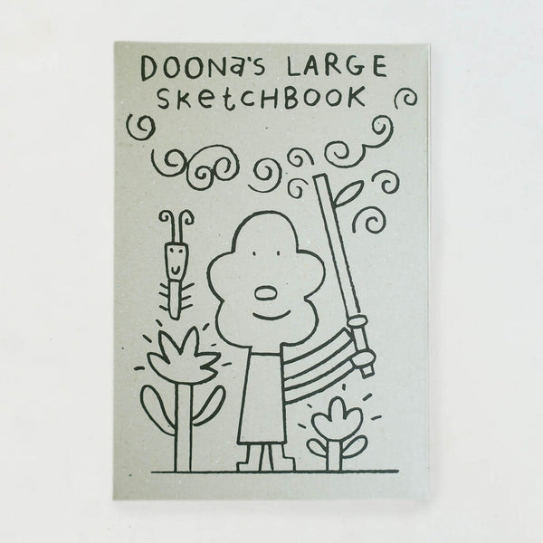 Woset sketchbook with grey cover showing a line drawing of a character holding a branch among flowers.