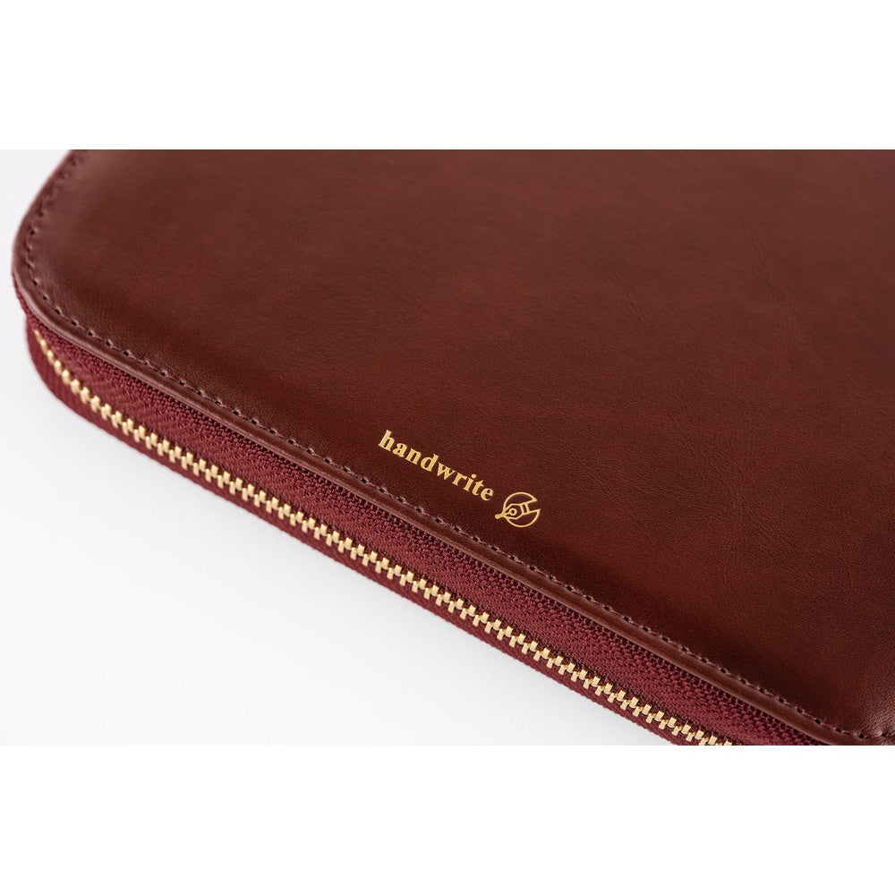 Close-up of Amarone zip-style A6 cover showing gold "handwrite" foil stamp and gold zipper teeth