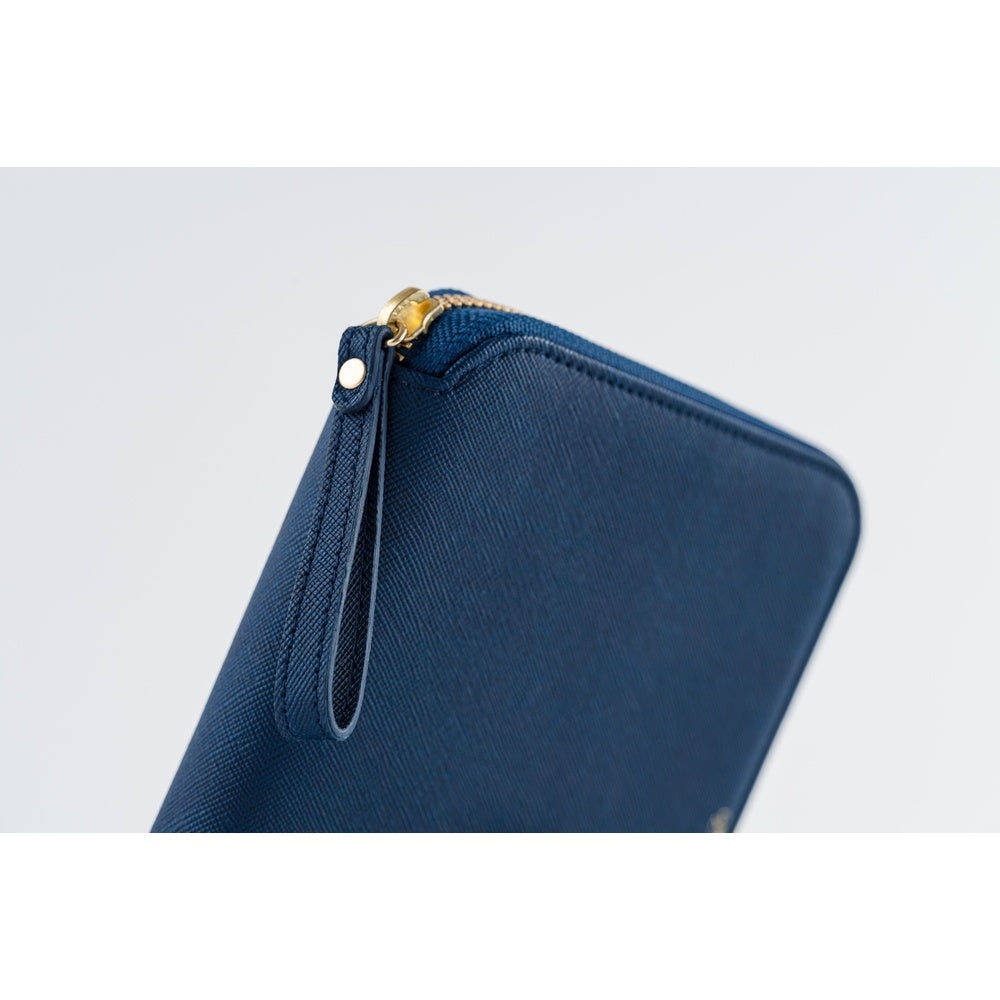 Close-up of the Lago A6 planner cover corner, showing gold zipper pull and leather pull tab.