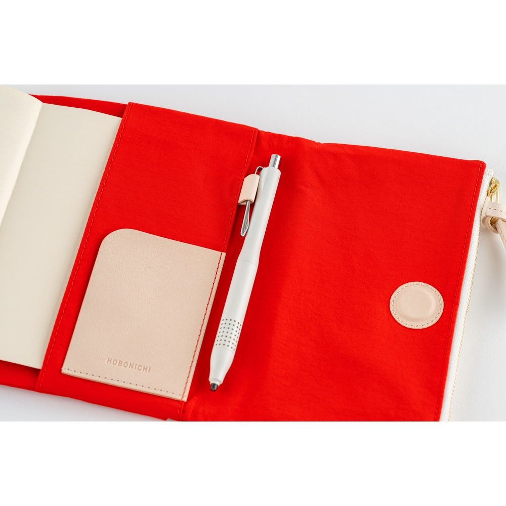 Open Hobonichi A6 book cover in Red, showing inner pocket, pen in loop and Hobonichi card holder.