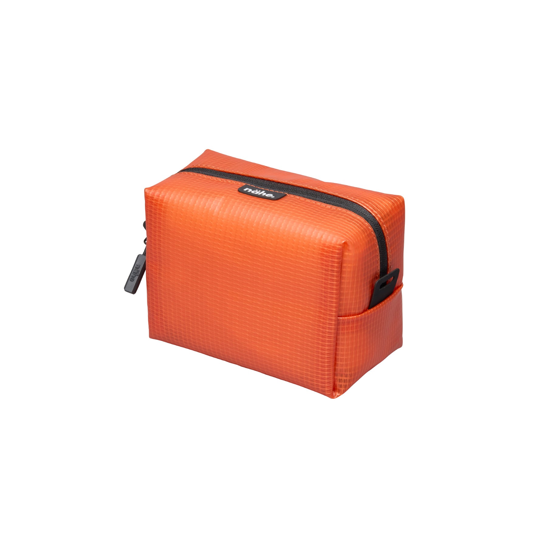Nähe Soft Grid Pouch in Orange, a small boxy grid-textured case with black top zipper and side pull tab.