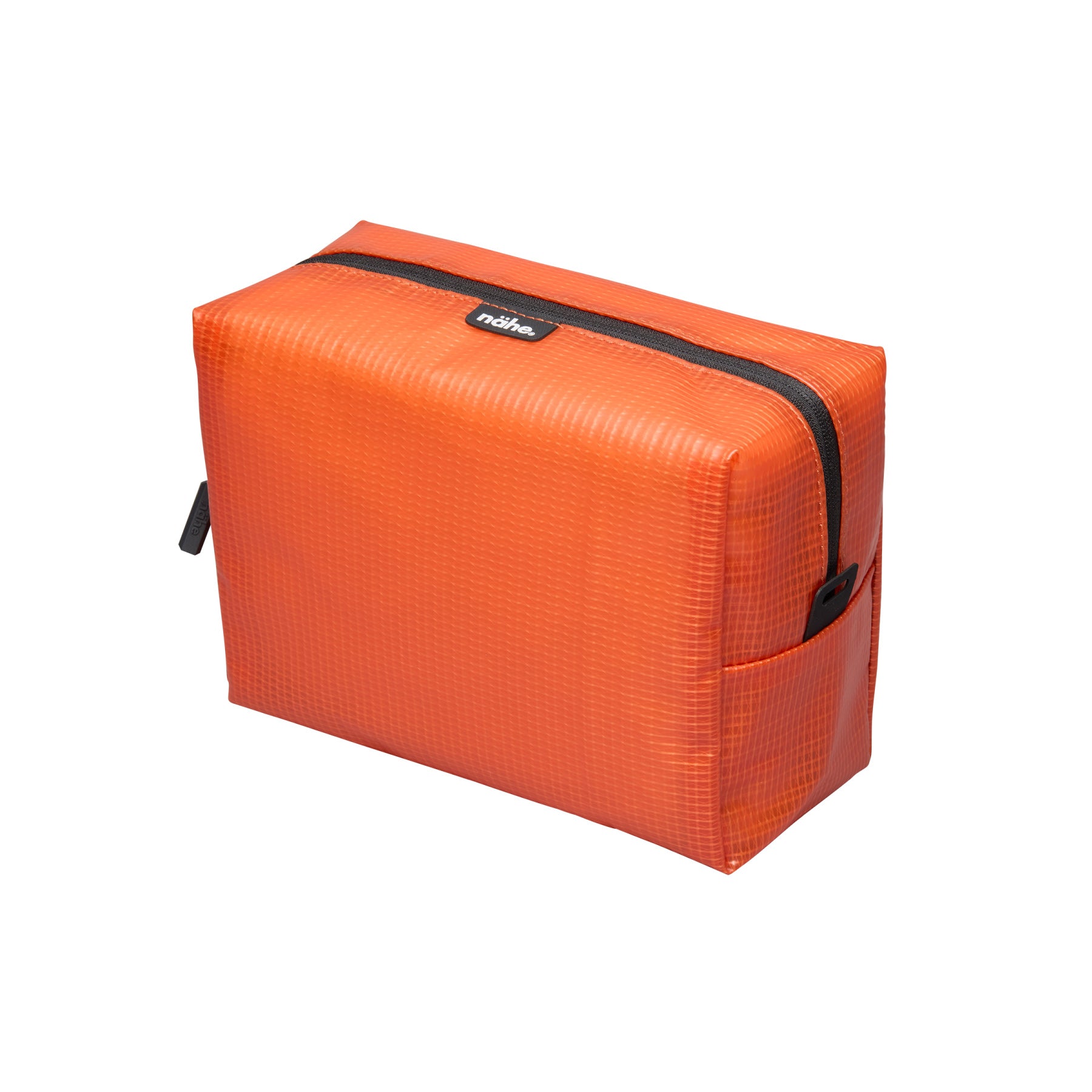 Nähe Soft Grid Pouch in Orange, a boxy grid-textured zip pouch with black zipper and side pocket
