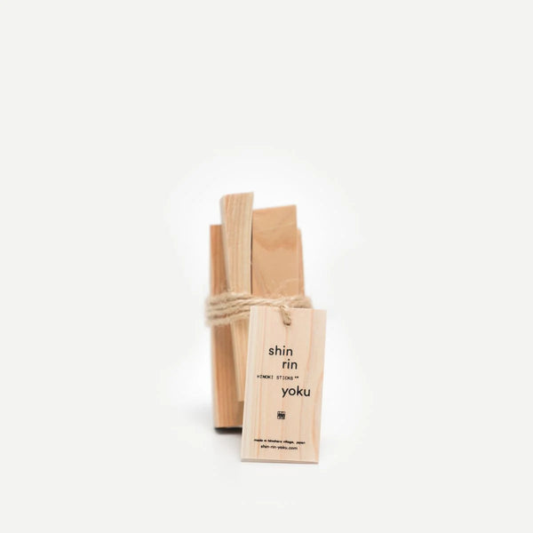 Bundle of pale Hinoki wood sticks tied with twine, with a printed shin rin yoku wooden tag attached.