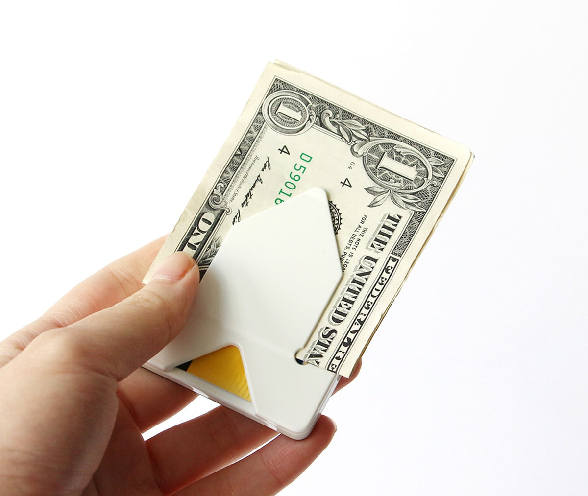 Hand holding a slim white card, money and coin case with a banknote clipped under the front panel.