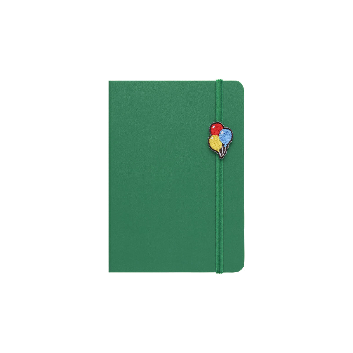 Green A6 planner with elastic band holding an embroidered charm of red, blue and yellow balloons.