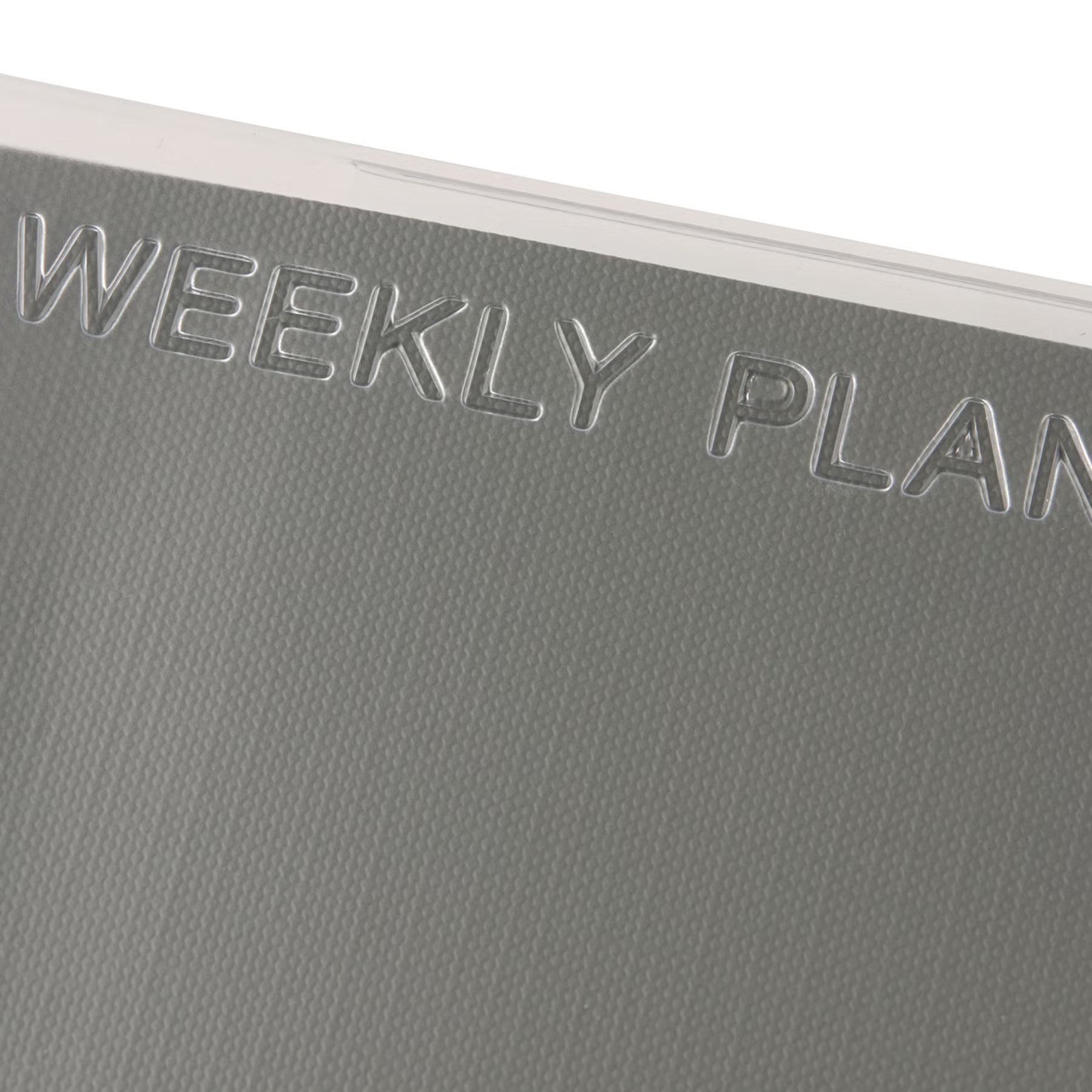 Close-up of the Gray textured paper cover with "Weekly Planner" embossed on the clear outer cover.