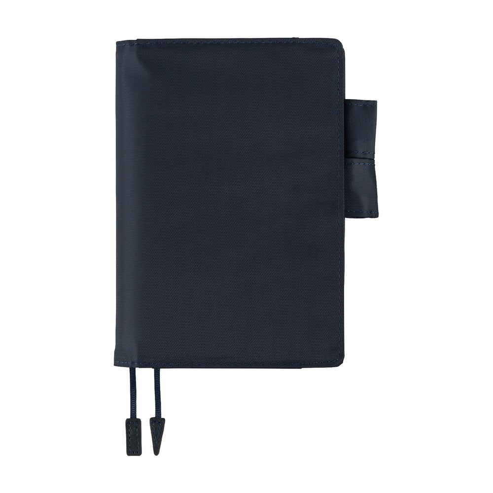 Hobonichi A6 planner cover in Navy, closed, with side pen loop and two ribbon bookmarks hanging below.