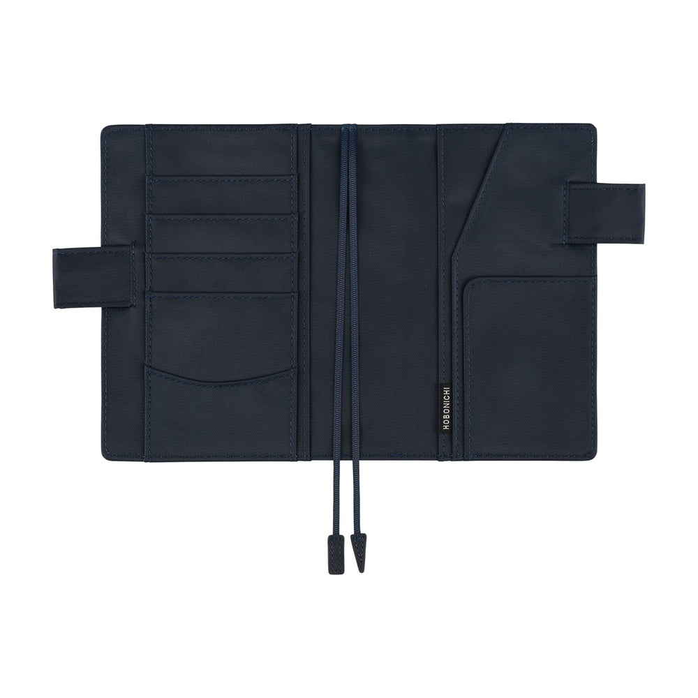 Hobonichi A6 book cover in Navy, opened flat to show card slots, pockets, side flaps and bookmark cords.