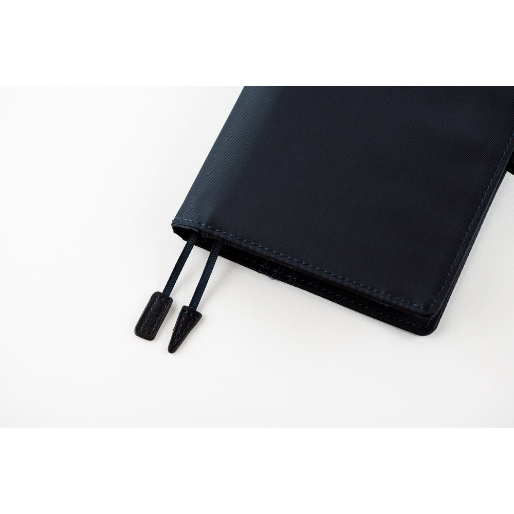 Close-up of a Hobonichi A6 book cover in Navy, showing stitched edge and two flat bookmark cords.