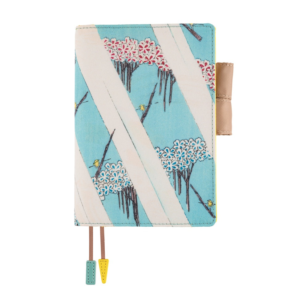 Hobonichi A6 planner cover in light blue with cherry blossom trees, pen loop and two ribbon bookmarks.