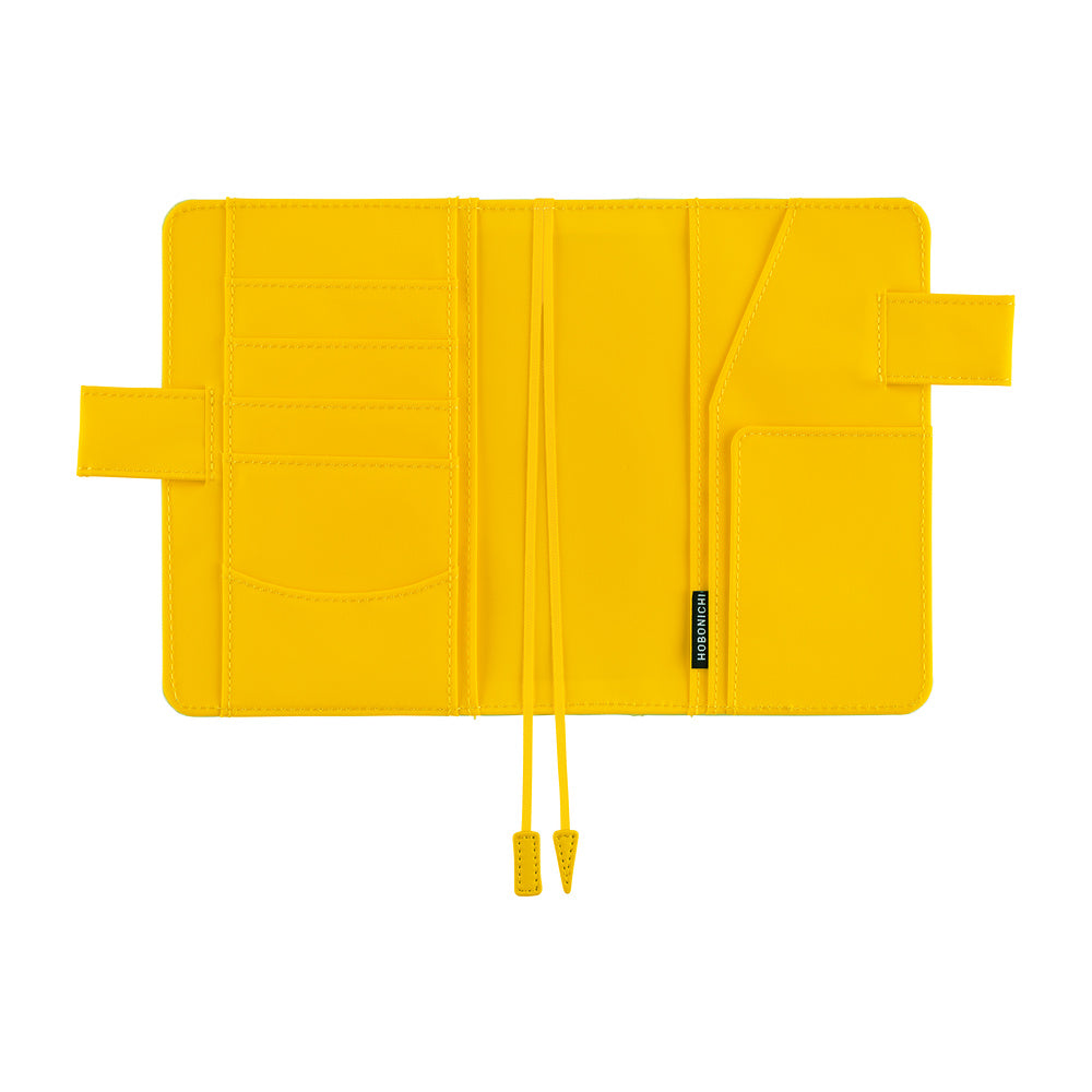 Hobonichi A6 book cover in Fresh Citron, opened flat to show card slots, pockets and two bookmarks.