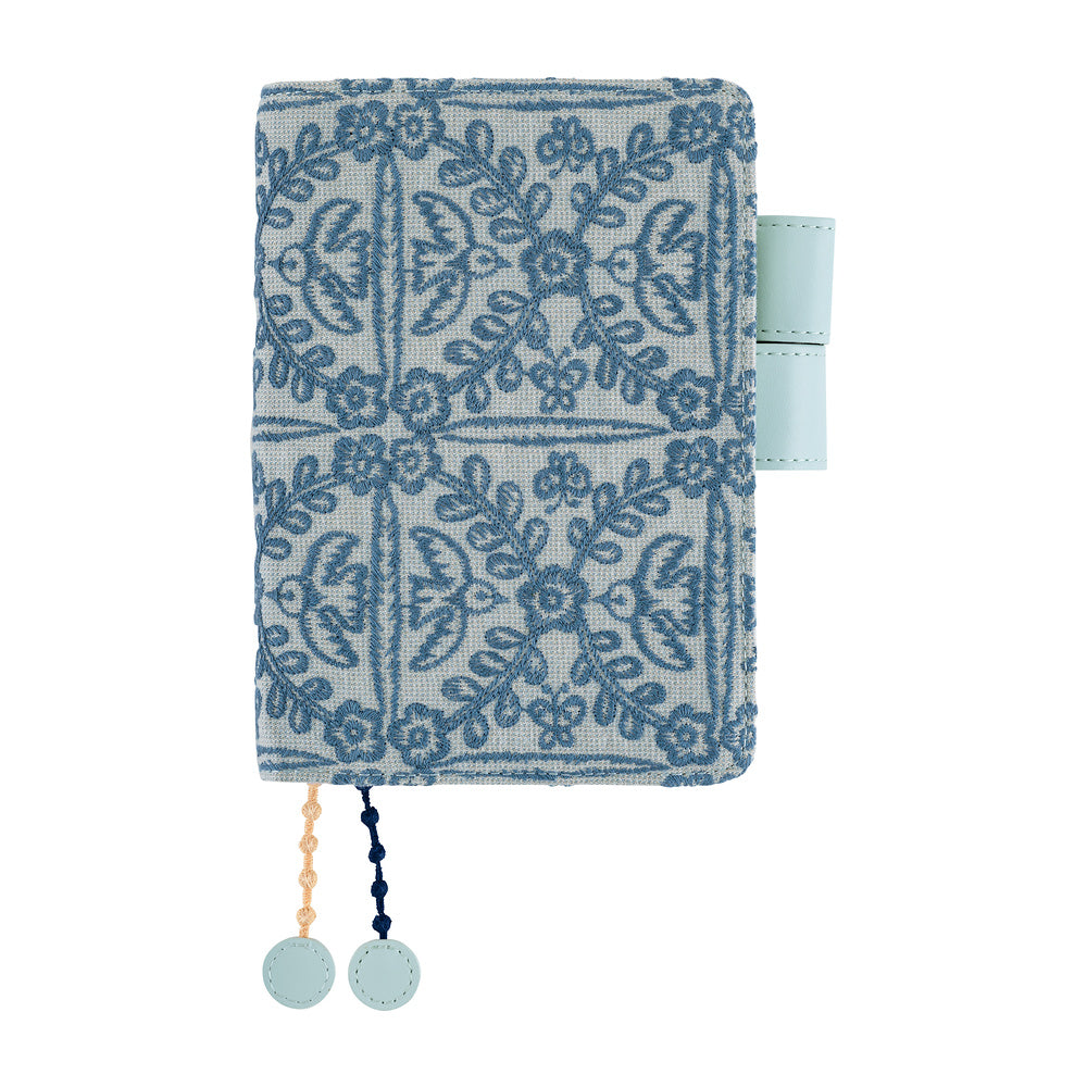 Hobonichi A6 book cover in Blue minä perhonen embroidered floral fabric with pen loop and two bookmark charms.