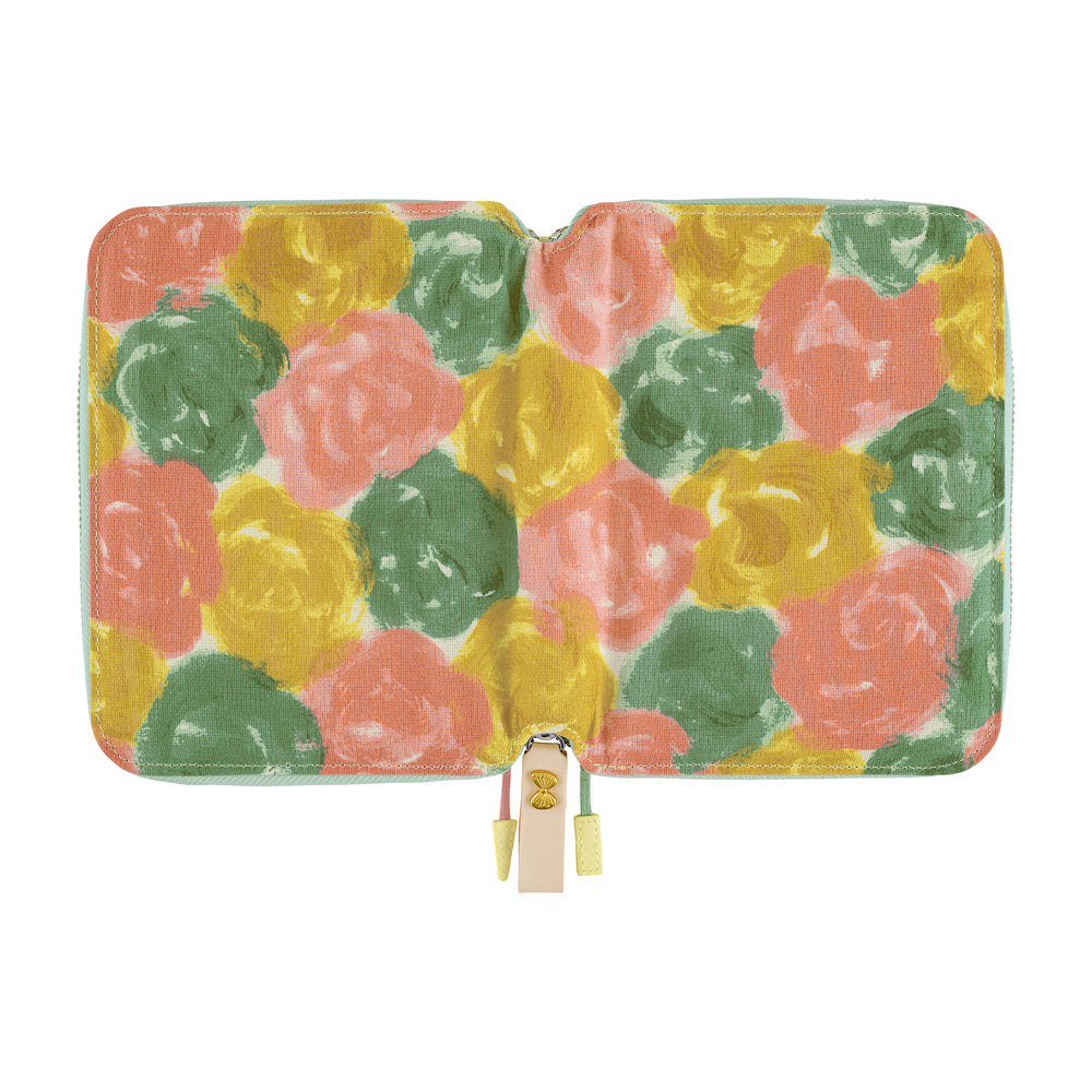 Open A6 book cover laid flat, showing Pink Multi painted rose fabric with zipper and leather pull tab.