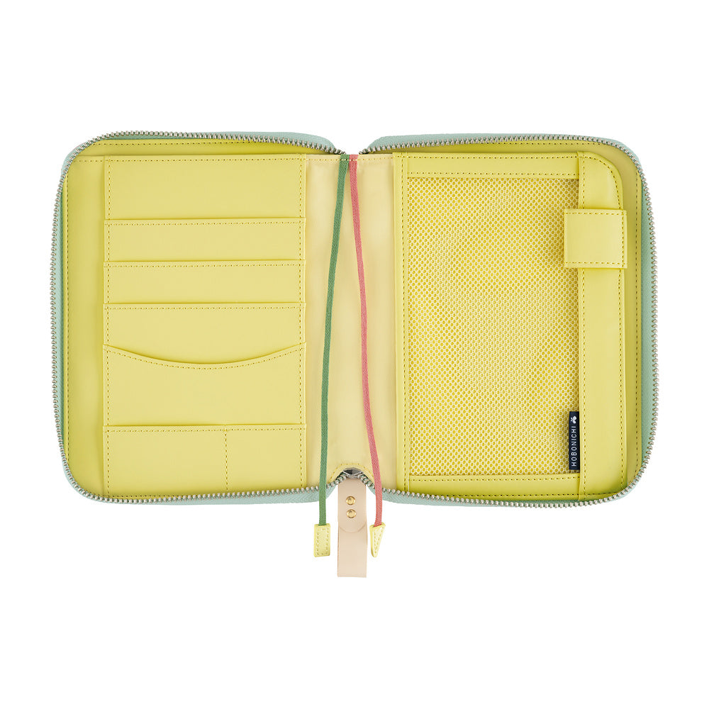 Hobonichi A6 book cover open flat, showing yellow interior with card slots, mesh pocket and pen loop