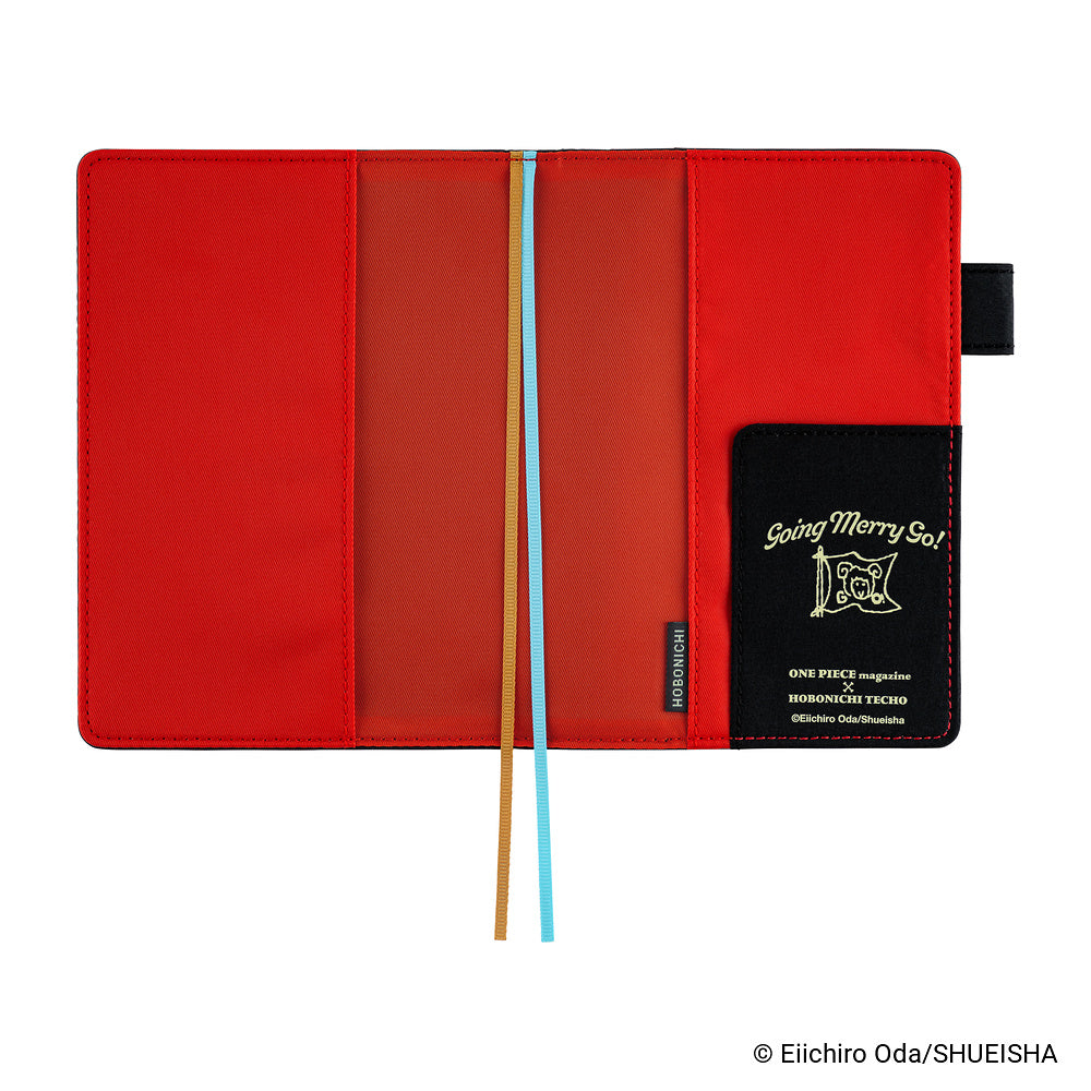 Open A6 book cover showing red interior, two ribbon bookmarks, and Going Merry Go! pocket flap