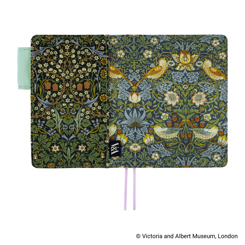 Hobonichi A6 planner cover opened flat, showing Dark Green floral and bird patterns with V&A label and ribbons
