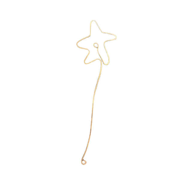 Hand-forged brass book jewelry bent into an outlined star atop a long slender stem with looped end.