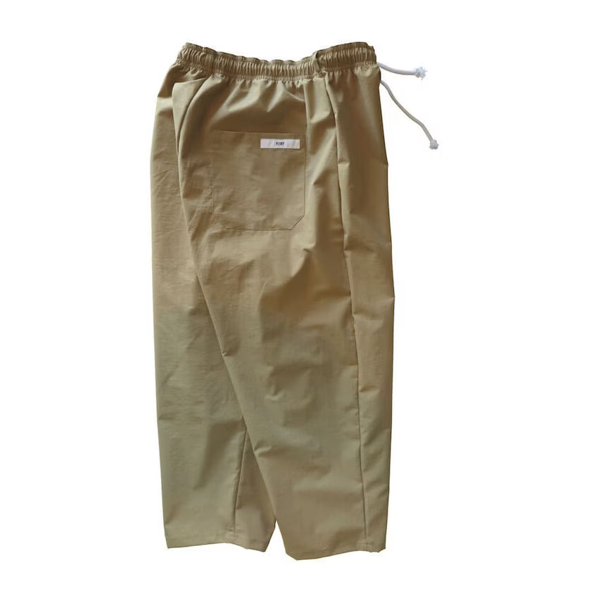 Beige Voiry Sunday Pants shown from the back, with elastic drawstring waist and patch back pocket