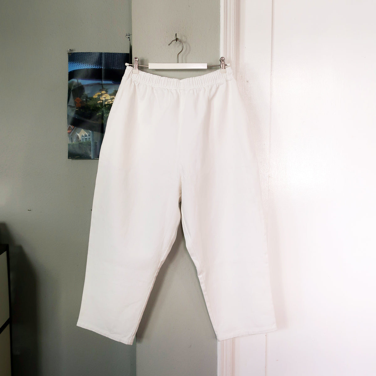Voiry Sunday Pants in White Denim on a hanger, elastic waist with drawstring, cropped relaxed legs.