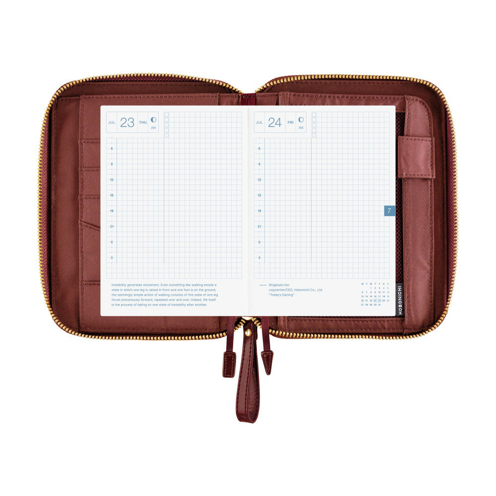 Hobonichi A6 zip book cover in Amarone, open to show card slots, pen loop and daily grid pages