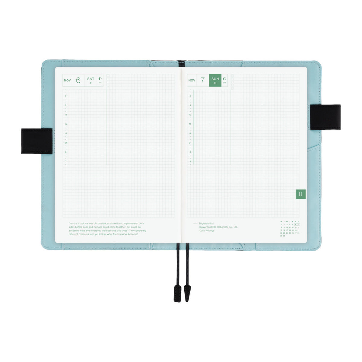 Hobonichi A6 book cover in Blue Parasol, open flat to show grid daily pages, black bookmarks and side straps