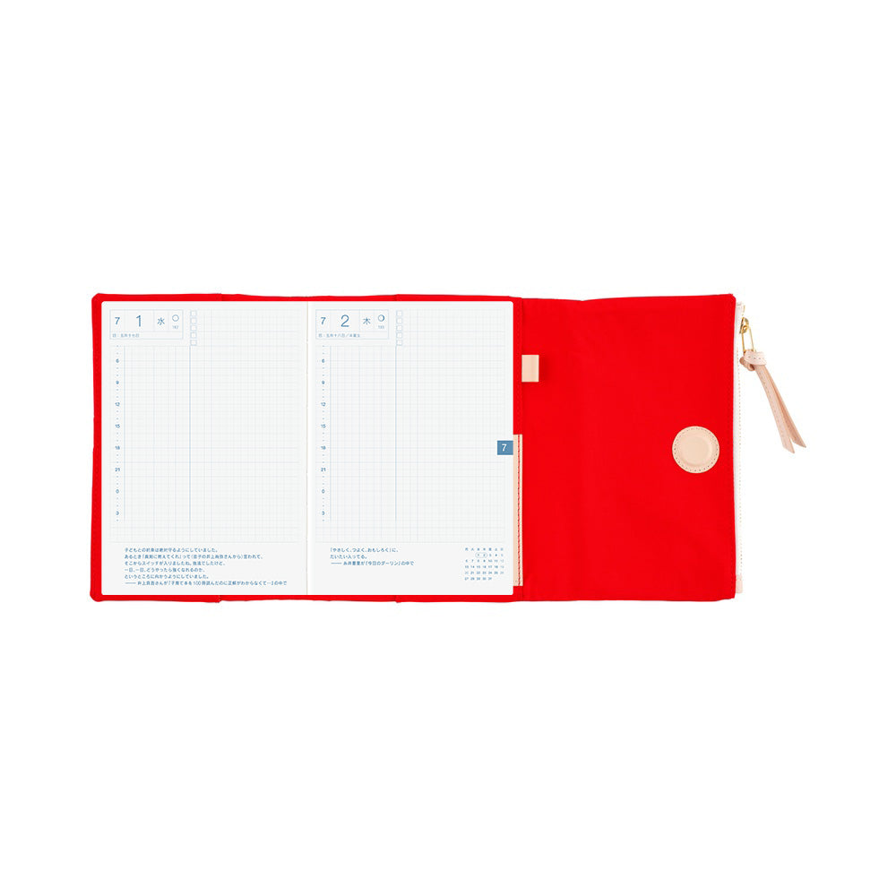 Open Red Hobonichi A6 book cover with grid daily pages and a zippered pouch flap with leather pull tab.