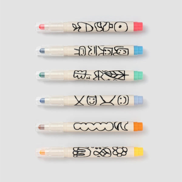 Six Woset markers arranged in a row, each with a doodle-printed cream barrel and a colored cap end.