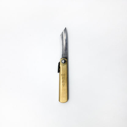 a gold foldable pocket knife with japanese writing embossed logo on handle