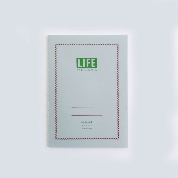 LIFE Pistachio N77 B6 notebook with pale grey card cover, green logo, red checked border and two ruled lines.